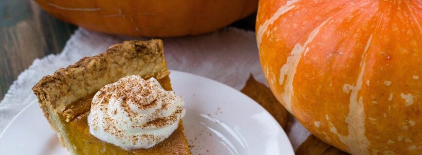 delectable sliced pumpkin pie on white ceramic plate